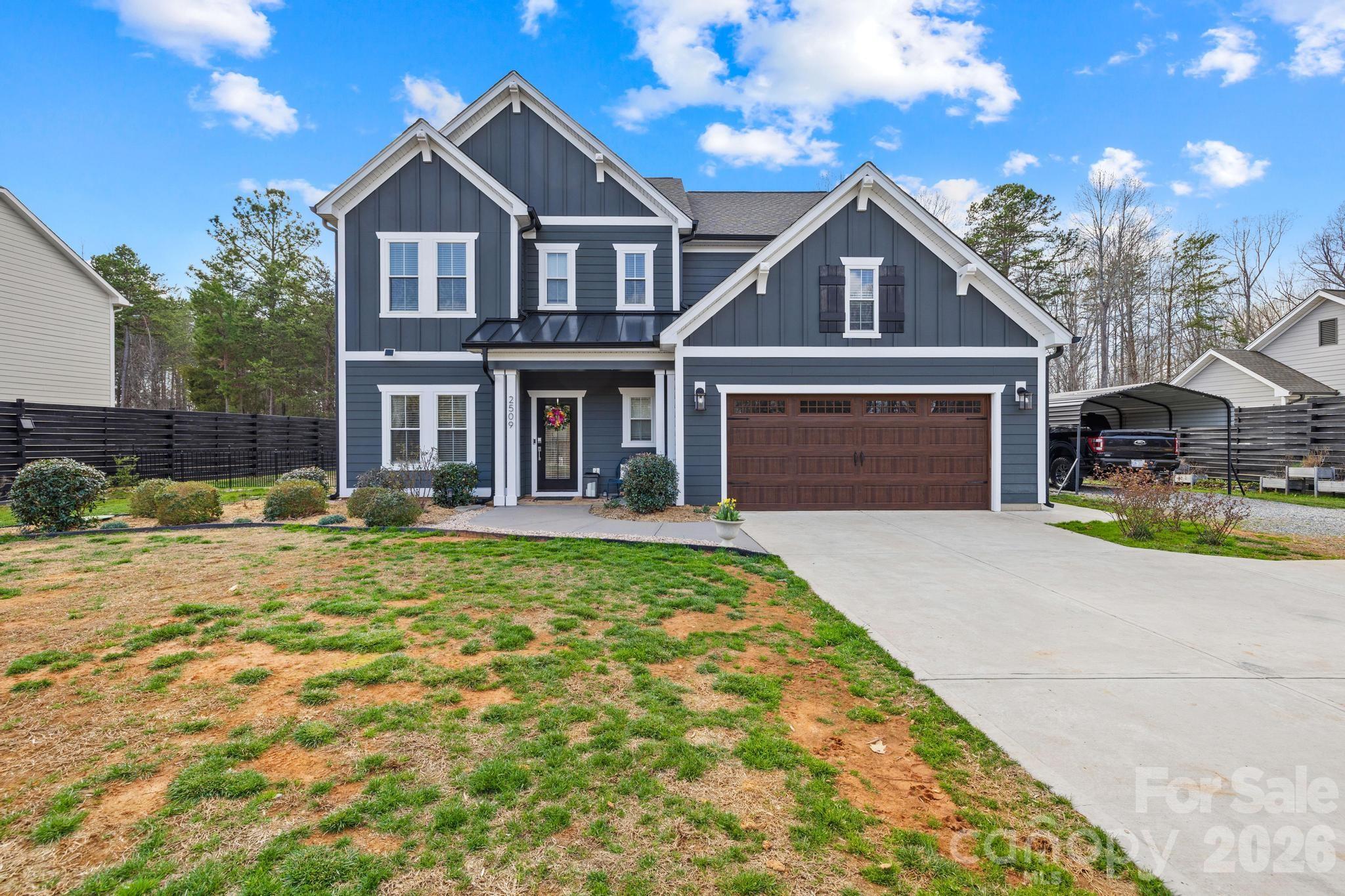 a front view of a house with yard and garage