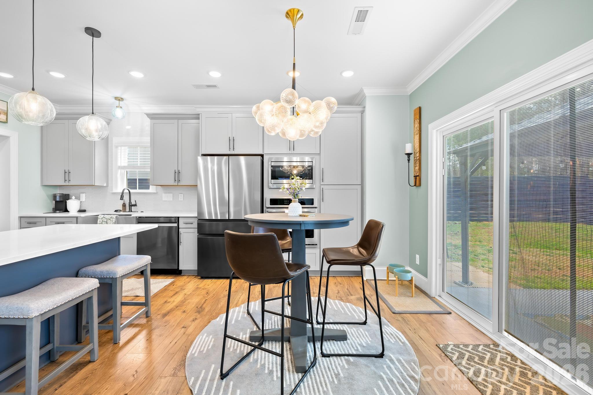 2509 St James Church Road Denver, NC 28037 - Photo 15 of 41 a view of a dining room with furniture a chandelier and wooden floor