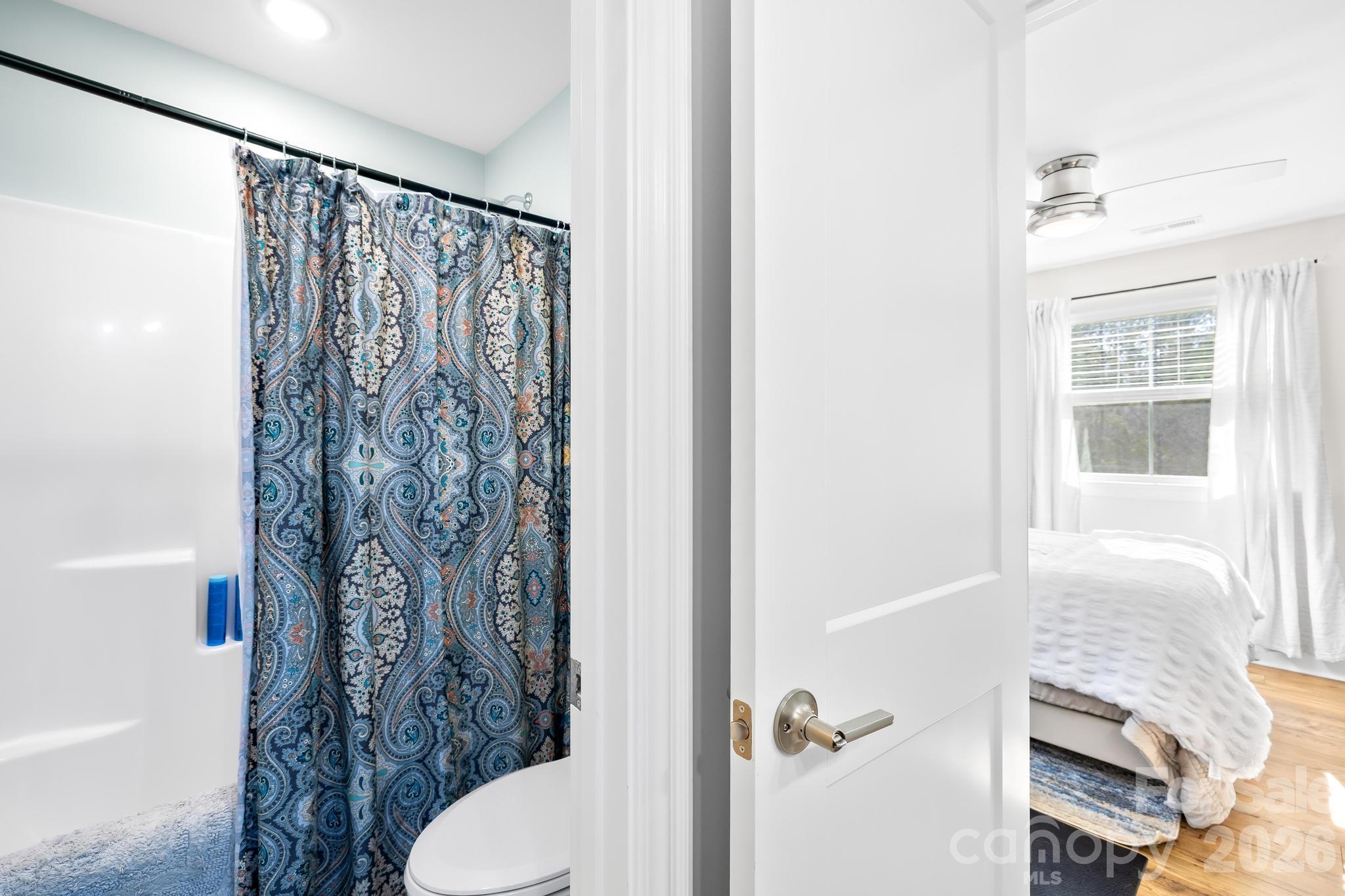 2509 St James Church Road Denver, NC 28037 - Photo 22 of 41 a bathroom with a shower curtain and a toilet