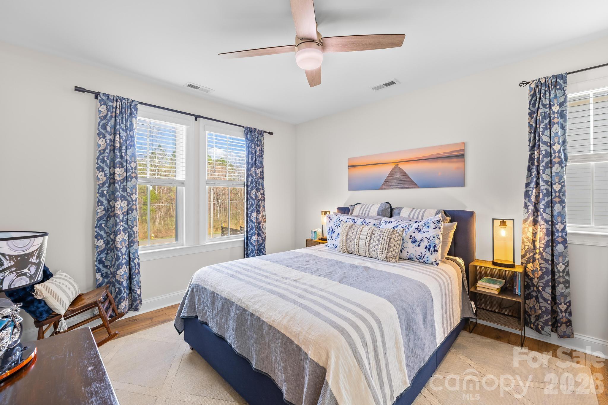 2509 St James Church Road Denver, NC 28037 - Photo 24 of 41 a bedroom with a large bed and a chandelier