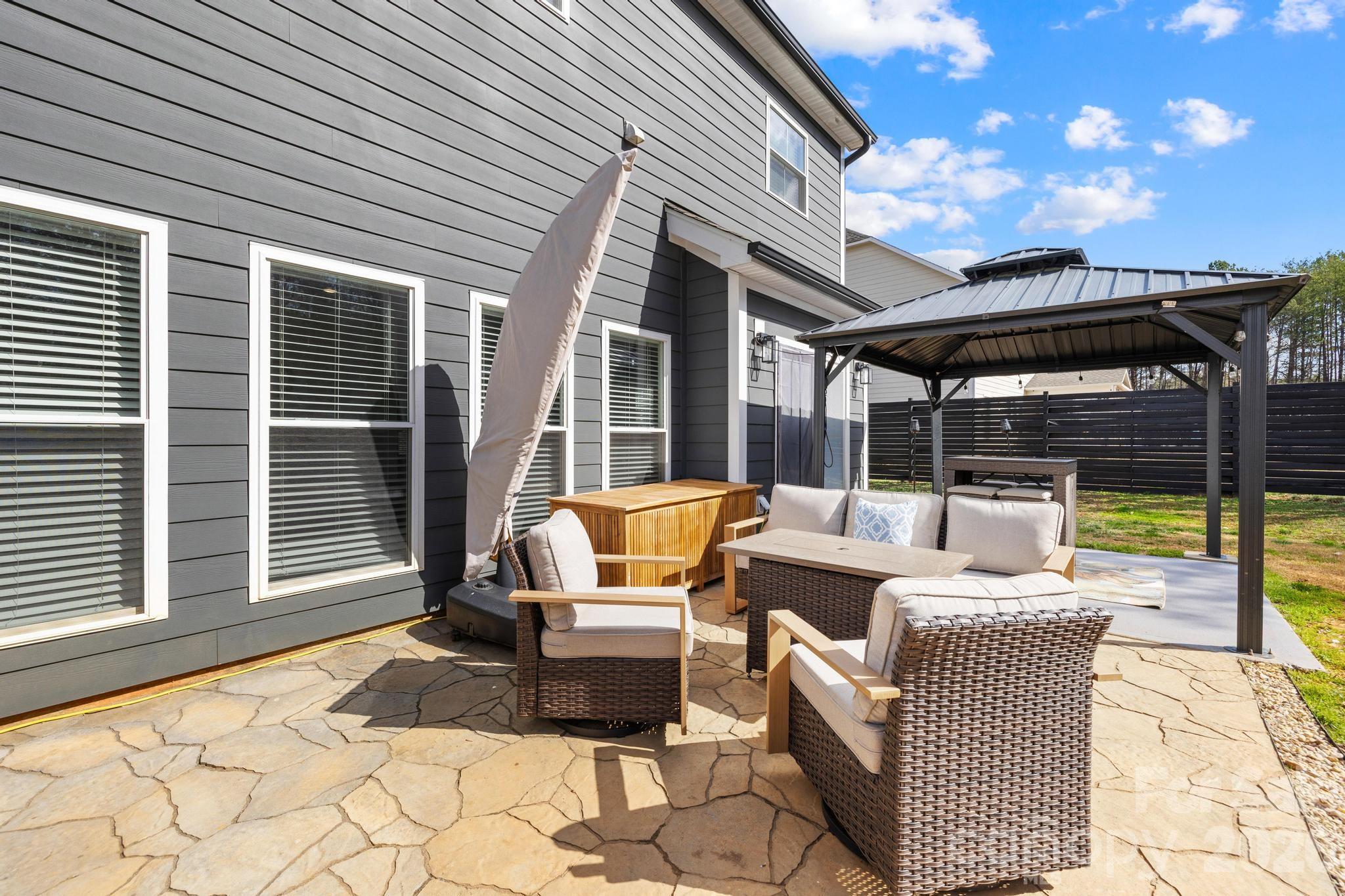 2509 St James Church Road Denver, NC 28037 - Photo 32 of 41 a view of a patio with a table chairs and a barbeque