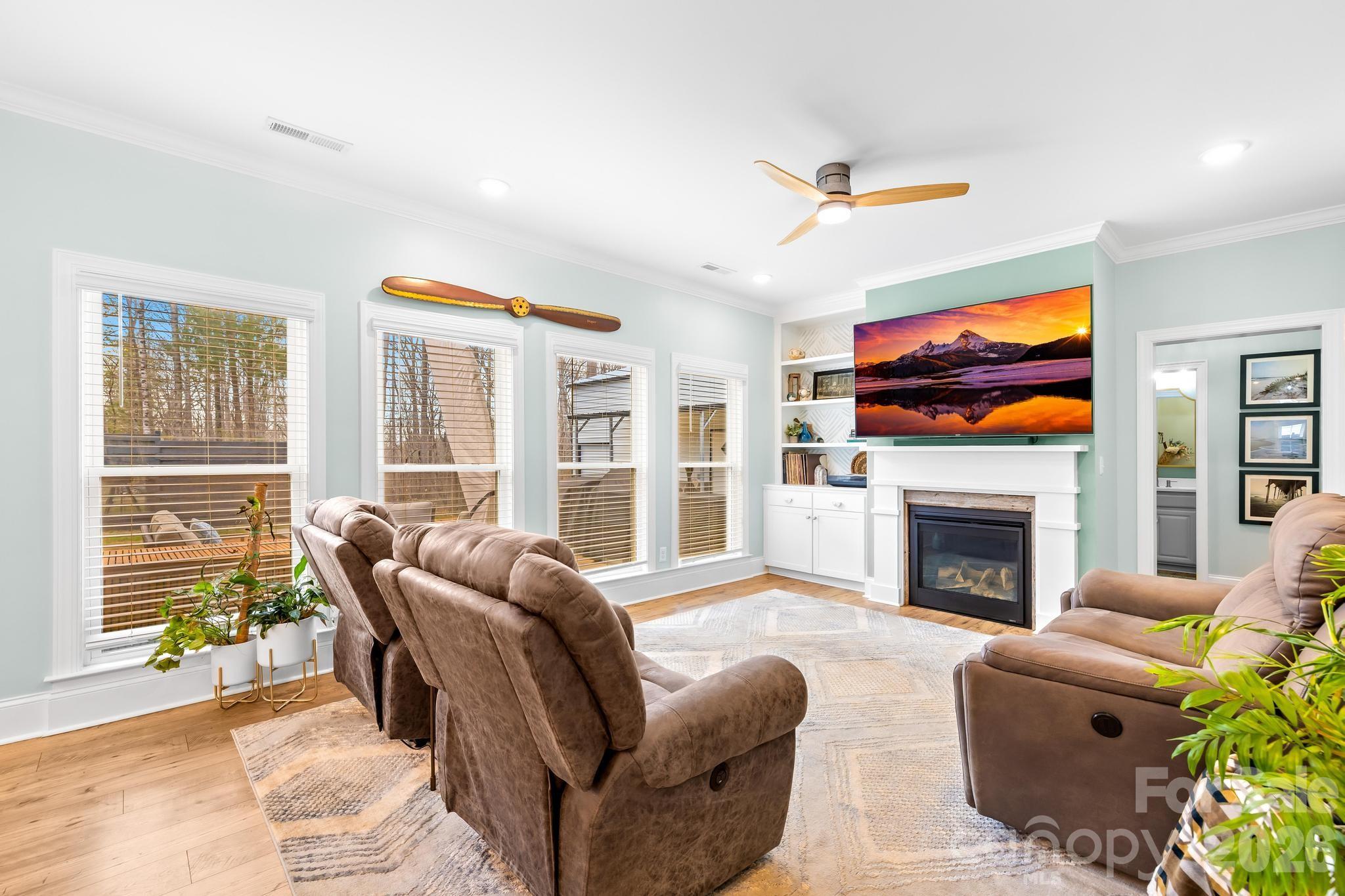 2509 St James Church Road Denver, NC 28037 - Photo 7 of 41 a living room with furniture a fireplace and a flat screen tv