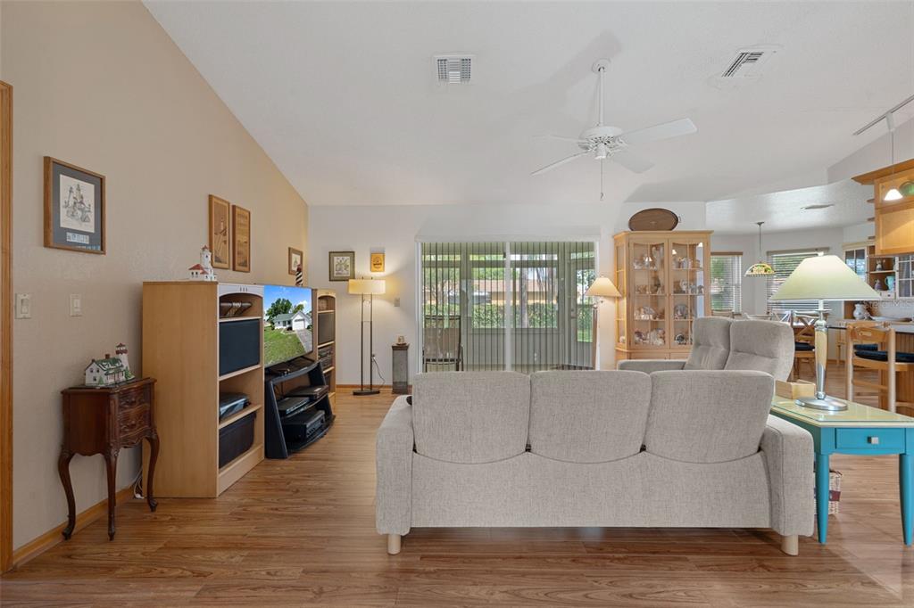 5035 Harbinger Road Spring Hill, FL 34608 - Photo 14 of 47 a living room with furniture and a flat screen tv