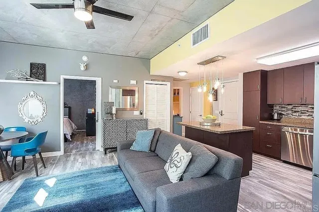 a living room with furniture and kitchen view