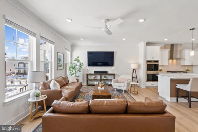 a living room with furniture wooden floor and a flat screen tv