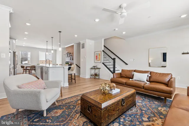 a living room with furniture kitchen view and a table