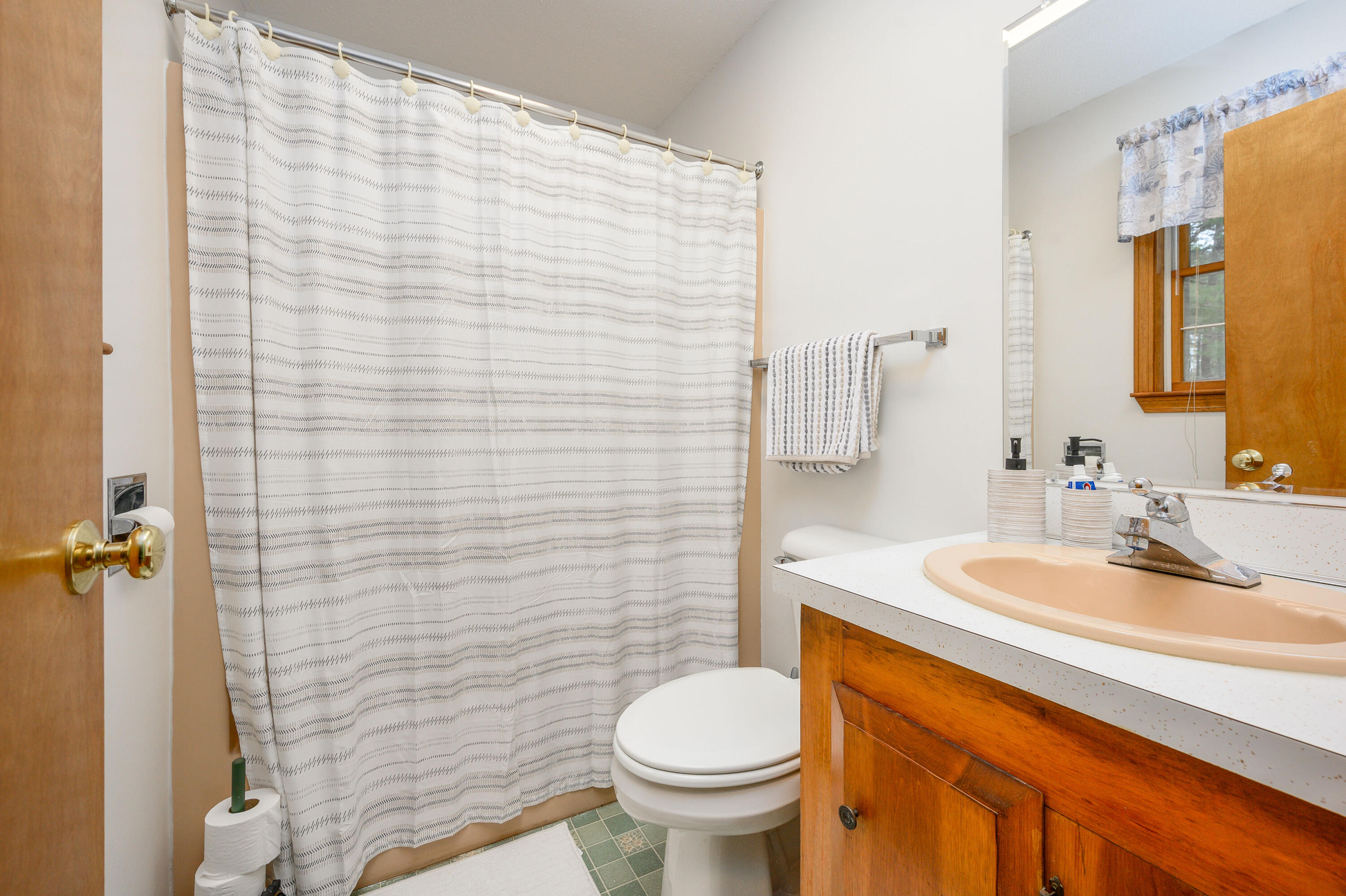 1500 Bridge Road Eastham, MA 02642 - Photo 27 of 41 a bathroom with a sink a toilet and shower curtain