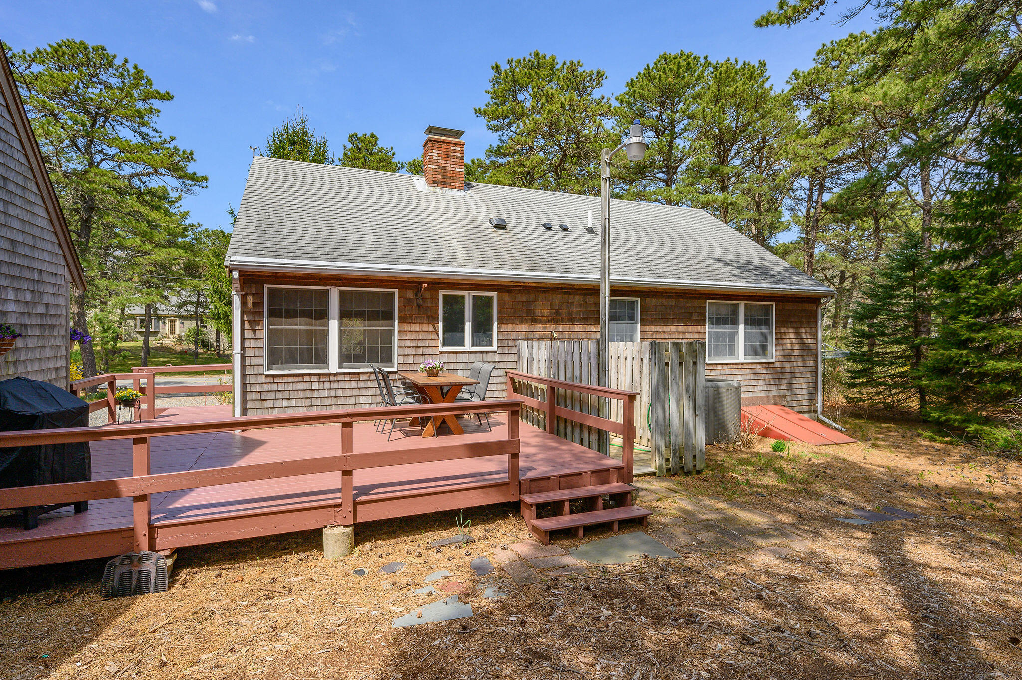 1500 Bridge Road Eastham, MA 02642 - Photo 35 of 41 a backyard of a house with a garden and deck