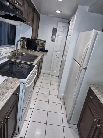 a kitchen with a sink a stove and a microwave