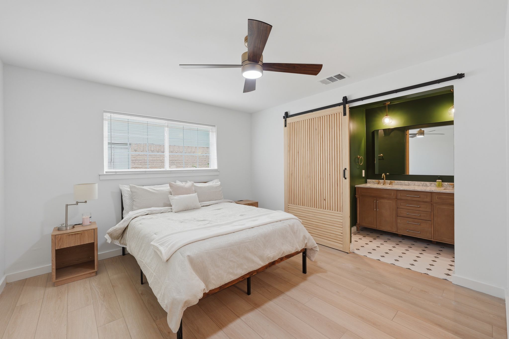 6804 Meadow Run Austin, TX 78745 - Photo 12 of 34 The property features light wood flooring, a window with blinds, and a ceiling fan