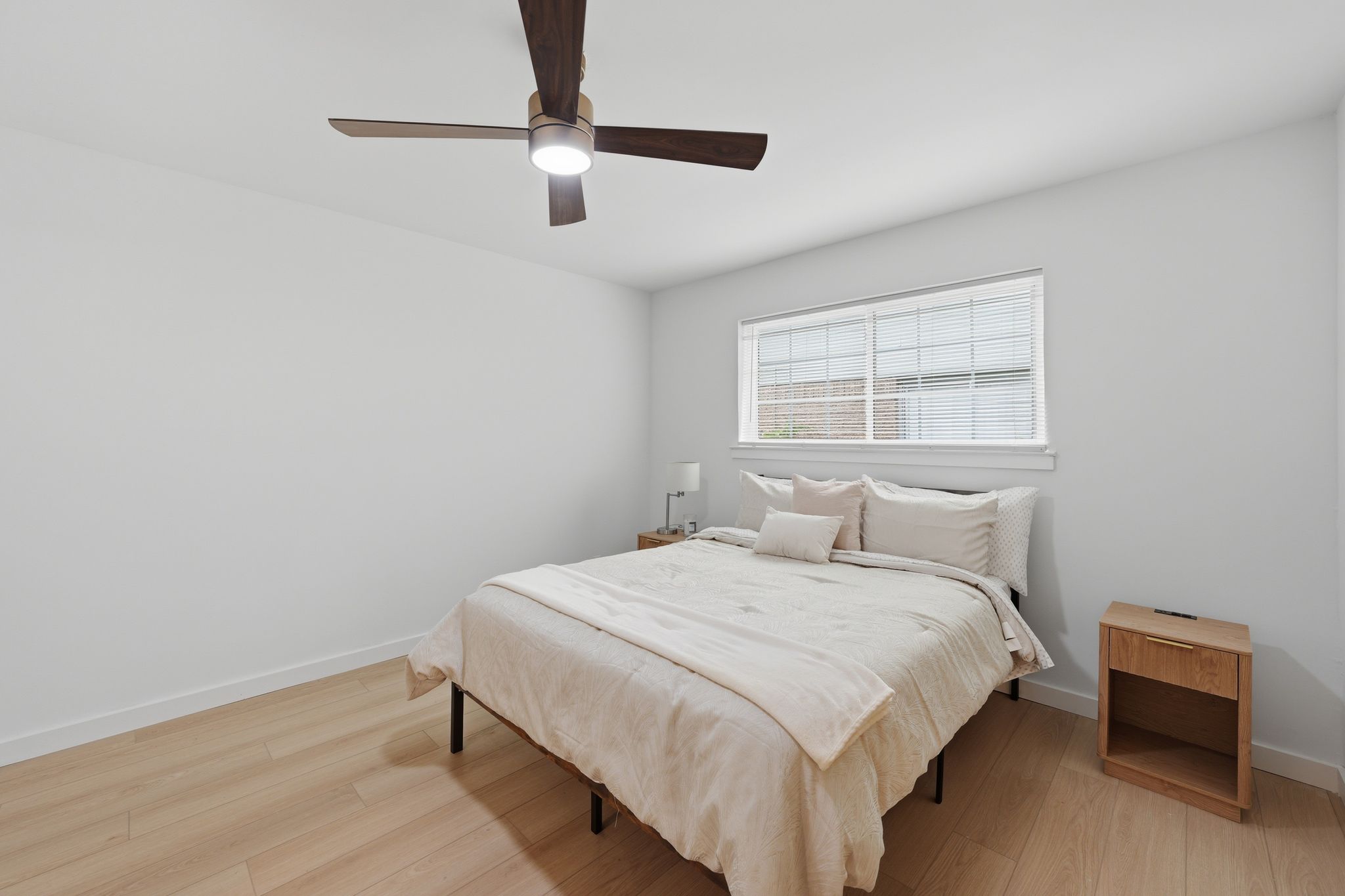 6804 Meadow Run Austin, TX 78745 - Photo 13 of 34 The room features light-colored flooring, a window with blinds, and a ceiling fan with integrated lighting