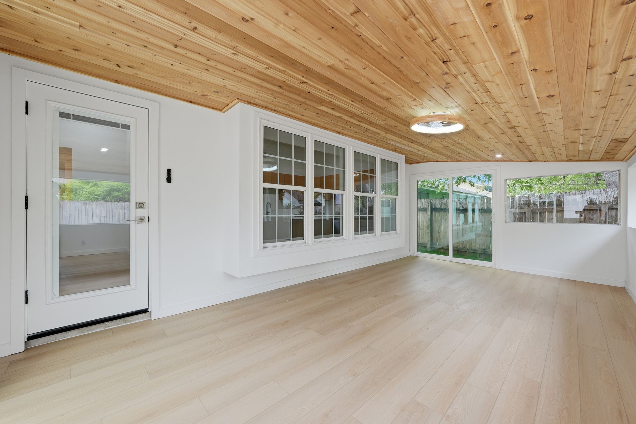 6804 Meadow Run Austin, TX 78745 - Photo 27 of 34 This inviting room features a natural wood plank ceiling, light-toned flooring, and white walls