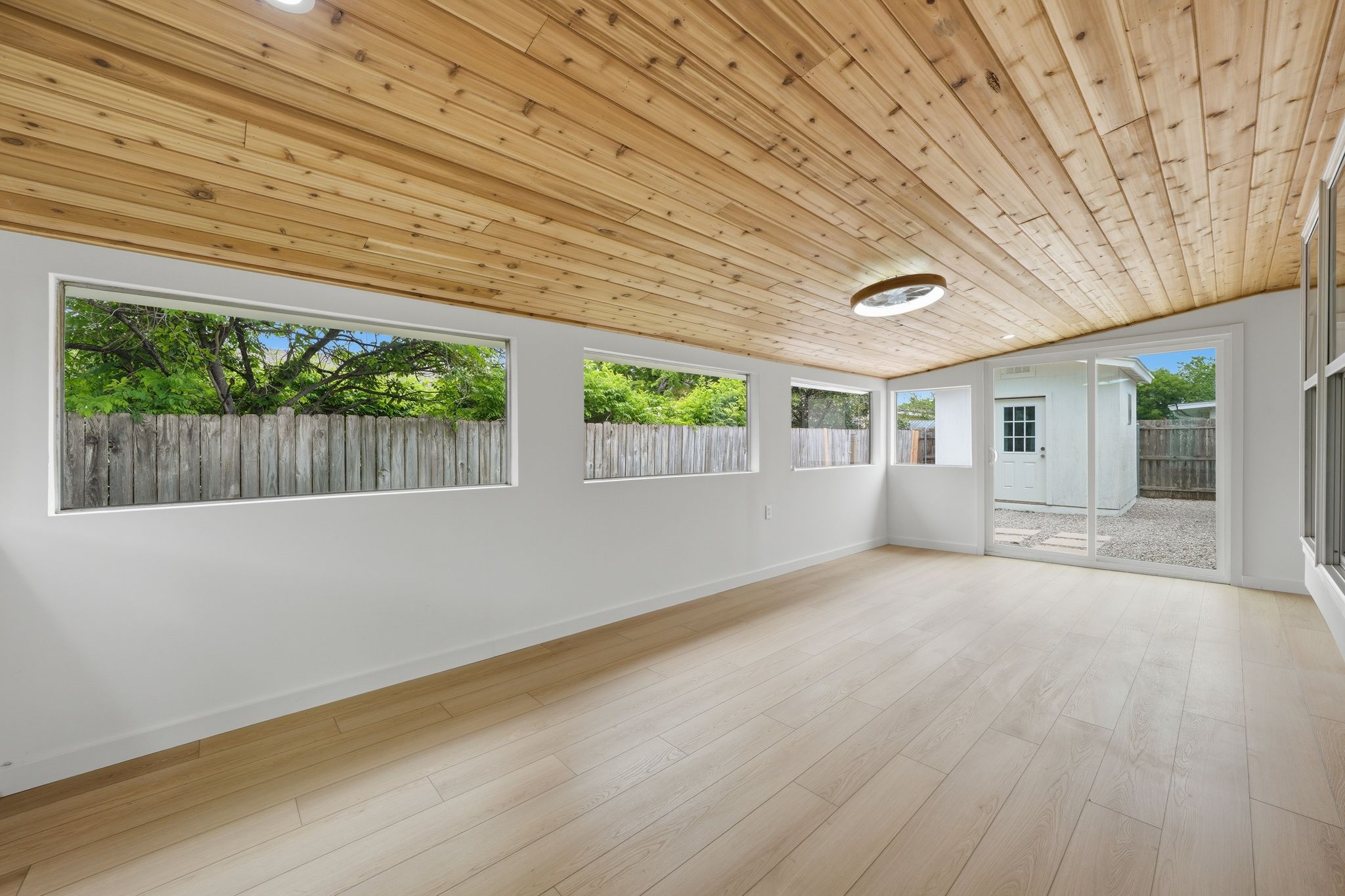 6804 Meadow Run Austin, TX 78745 - Photo 28 of 34 The property features a spacious room with a wood-paneled ceiling, light-colored flooring, and white walls
