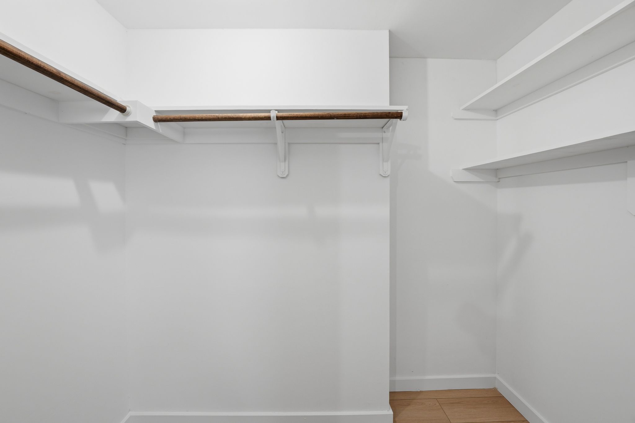 6804 Meadow Run Austin, TX 78745 - Photo 30 of 34 The closet features wood flooring, white walls, and built-in shelving with hanging rods