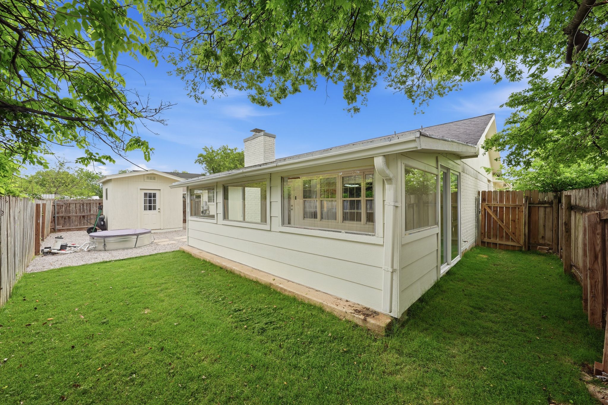 6804 Meadow Run Austin, TX 78745 - Photo 32 of 34 The property features a well-maintained lawn and a wooden privacy fence
