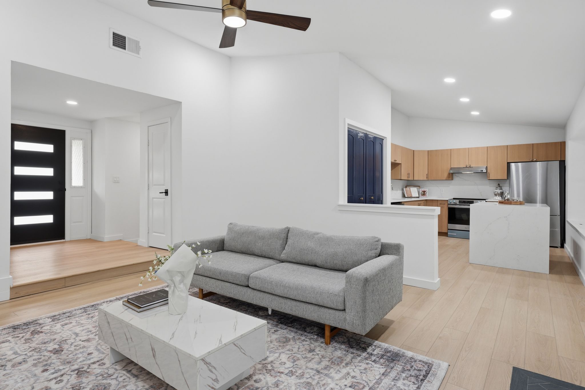 6804 Meadow Run Austin, TX 78745 - Photo 6 of 34 The main living area features light-toned hardwood flooring, recessed lighting, and a ceiling fan