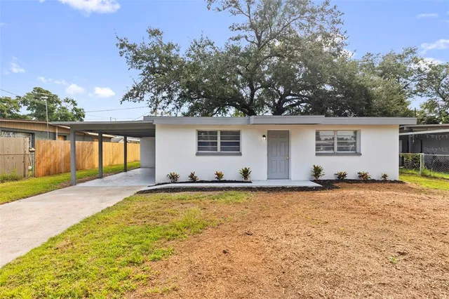 a view of a house with pool and a yard