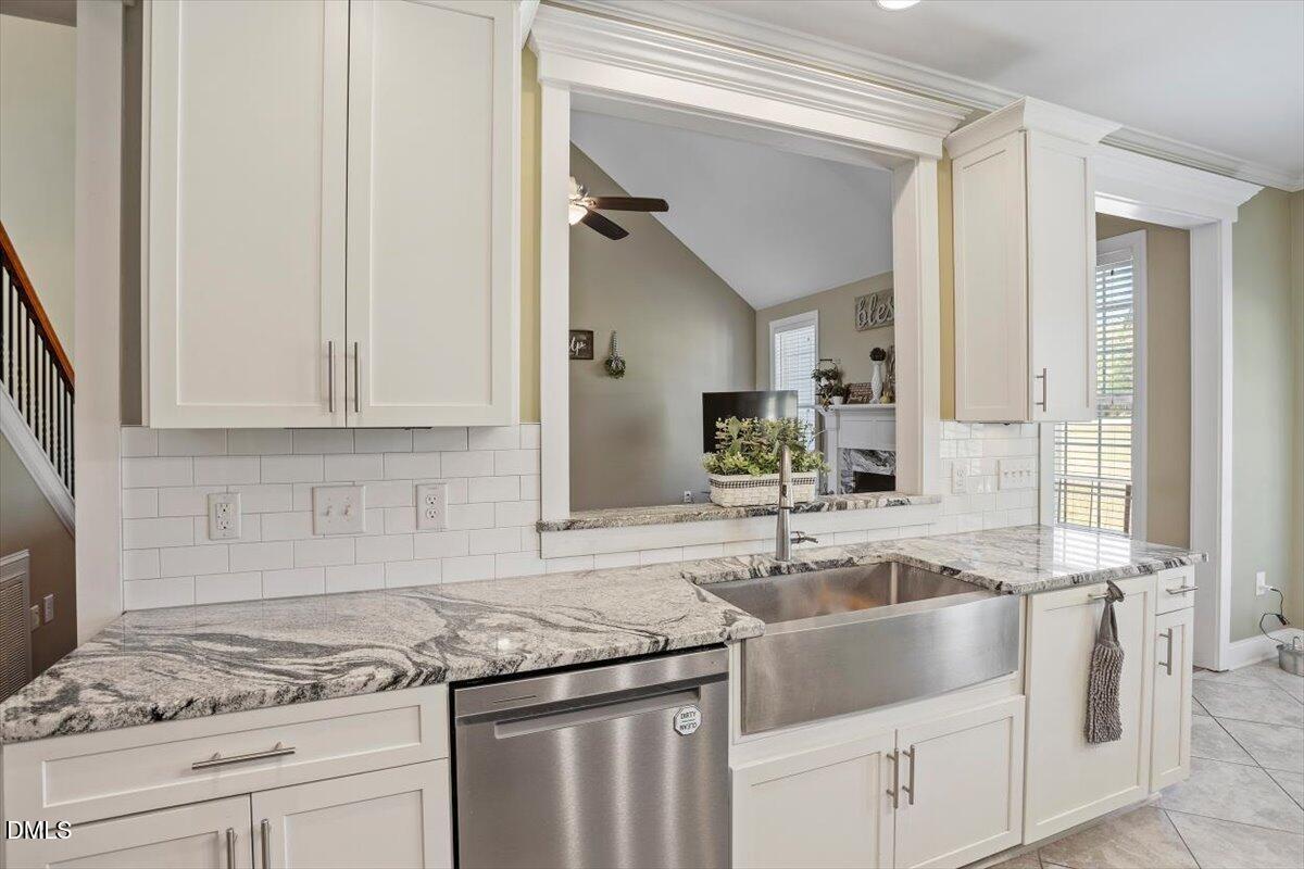 1001 Bellewood Farms Road Raleigh, NC 27603 - Photo 21 of 39 a kitchen with granite countertop a sink stainless steel appliances and cabinets