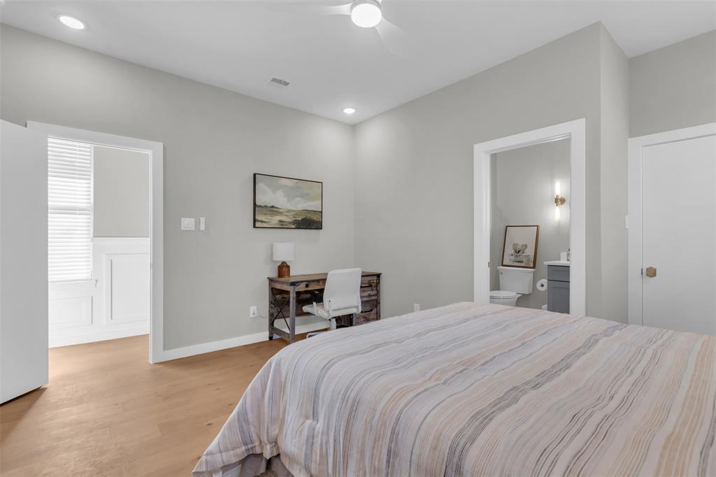 11107 Hillcrest Road Dallas, TX 75230 - Photo 13 of 29 a bedroom with a bed and a table