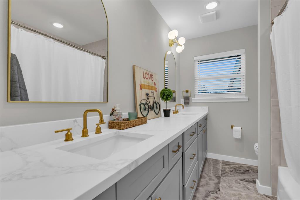 11107 Hillcrest Road Dallas, TX 75230 - Photo 16 of 29 a bathroom with a double vanity sink and a mirror