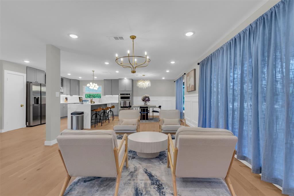 11107 Hillcrest Road Dallas, TX 75230 - Photo 25 of 29 a living room with furniture a large window and kitchen view