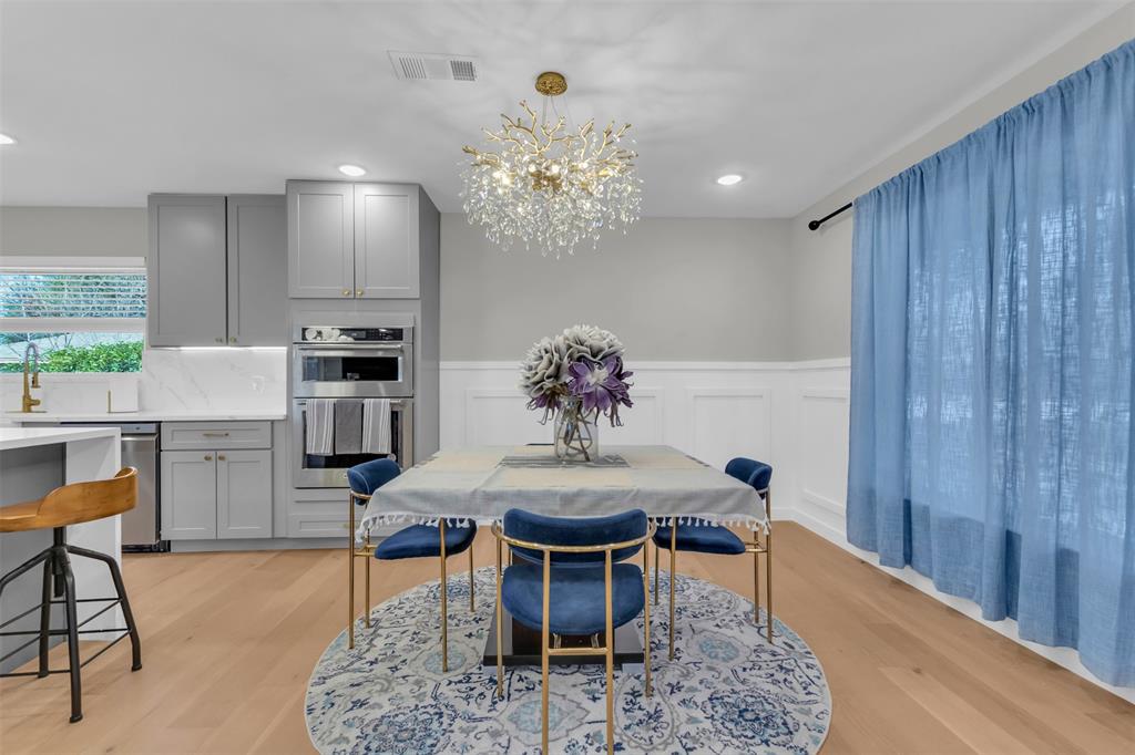 11107 Hillcrest Road Dallas, TX 75230 - Photo 4 of 29 a dining room with furniture a chandelier and kitchen view