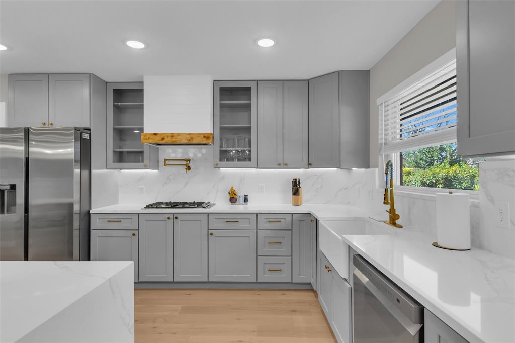 11107 Hillcrest Road Dallas, TX 75230 - Photo 6 of 29 a kitchen with a sink and refrigerator