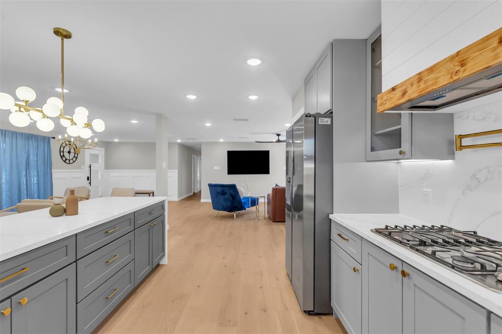 11107 Hillcrest Road Dallas, TX 75230 - Photo 7 of 29 a kitchen with a sink and a stove top oven