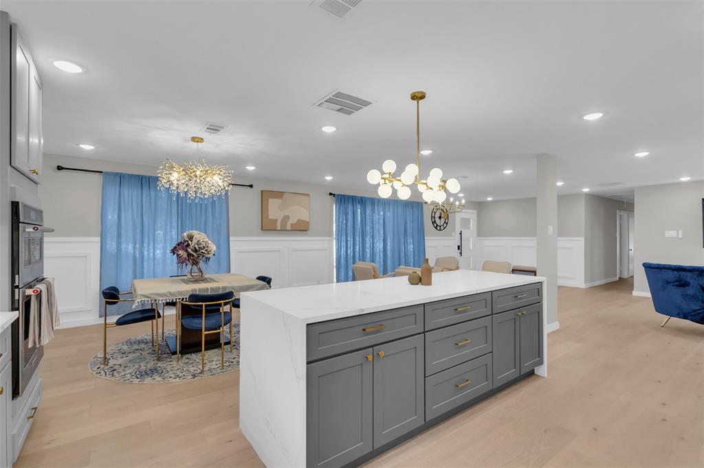 11107 Hillcrest Road Dallas, TX 75230 - Photo 8 of 29 a kitchen with stainless steel appliances kitchen island granite countertop a sink and cabinets