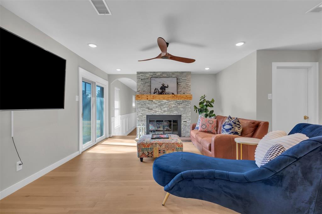 11107 Hillcrest Road Dallas, TX 75230 - Photo 9 of 29 a living room with furniture a flat screen tv and a fireplace