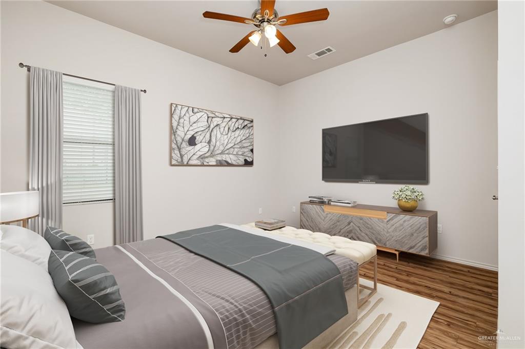 810 Taylor St Mission Mission, TX 78572 - Photo 11 of 12 a bedroom with a bed and a flat screen tv