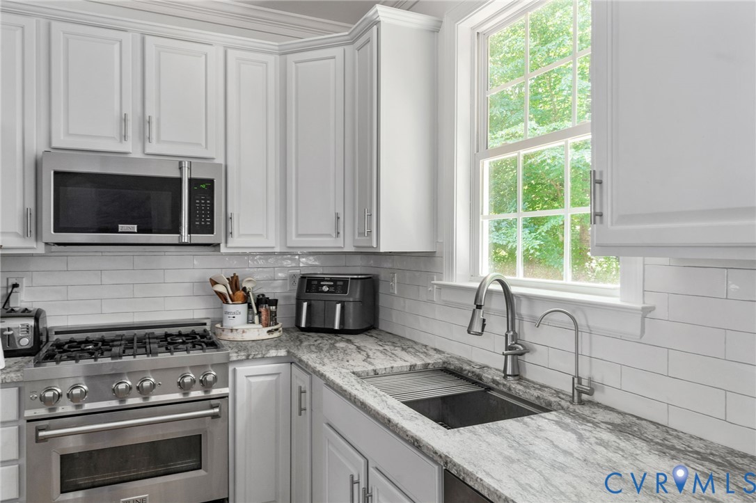 1755 Dispatch Road Quinton, VA 23141 - Photo 32 of 86 a kitchen with granite countertop a stove a sink and a microwave