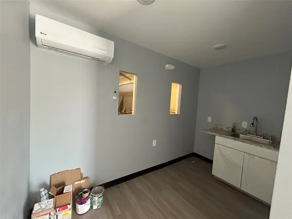 a room with a sink and cabinets