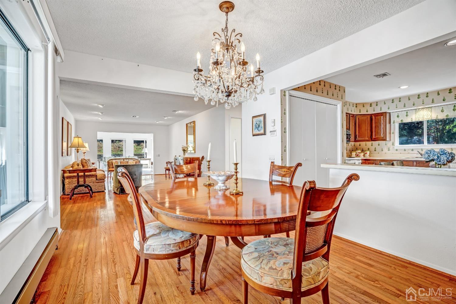 786 Pompton Road, Unit B Monroe Township, NJ 08831 - Photo 11 of 28 a dining room with furniture a chandelier and wooden floor