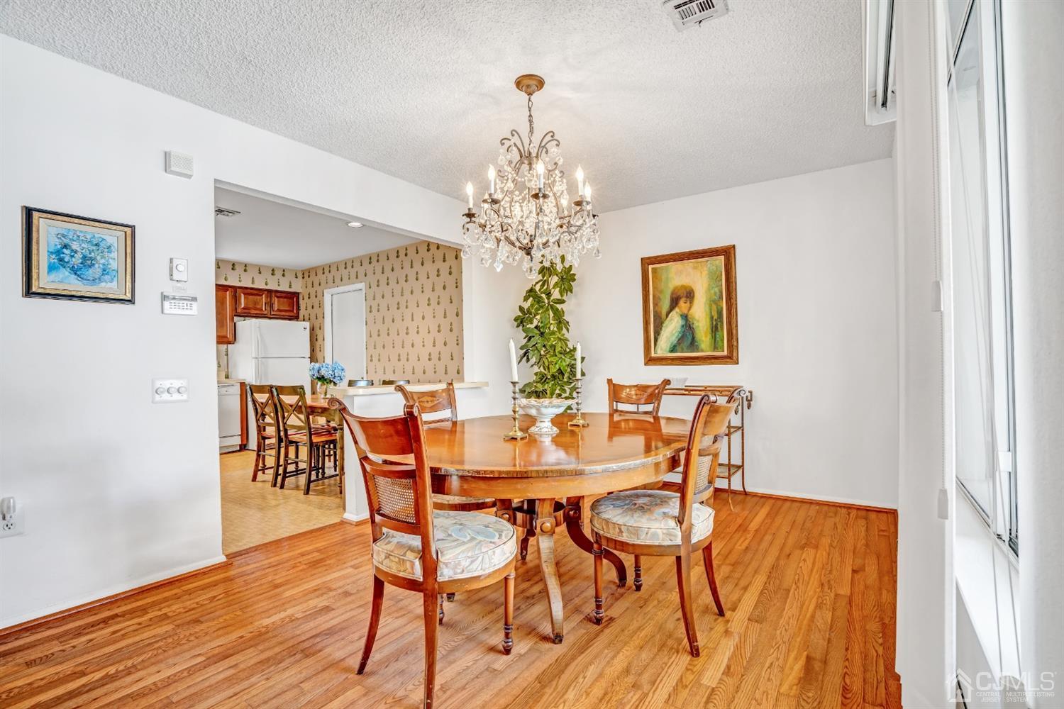 786 Pompton Road, Unit B Monroe Township, NJ 08831 - Photo 13 of 28 a view of a dining room with furniture and chandelier