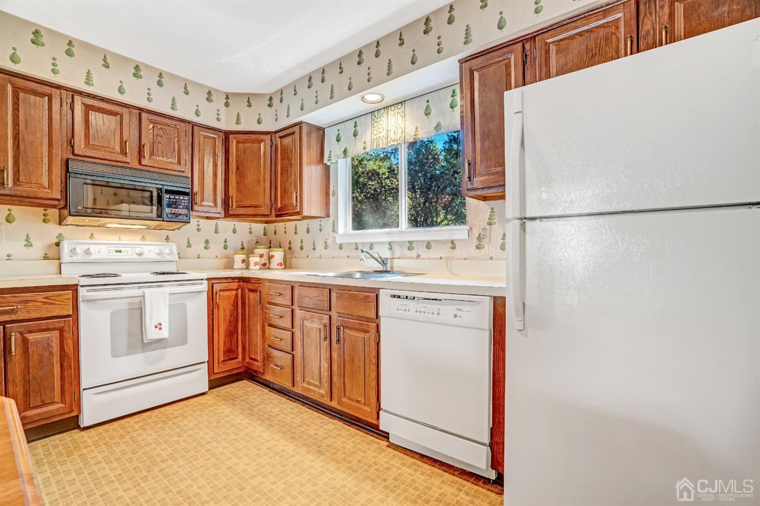 786 Pompton Road, Unit B Monroe Township, NJ 08831 - Photo 15 of 28 a kitchen with stainless steel appliances granite countertop a refrigerator sink and cabinets