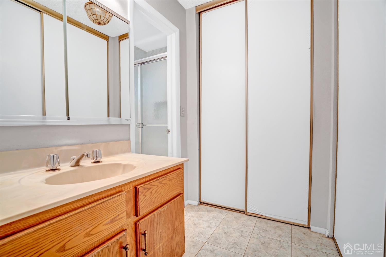 786 Pompton Road, Unit B Monroe Township, NJ 08831 - Photo 20 of 28 a bathroom with a sink a vanity and a mirror
