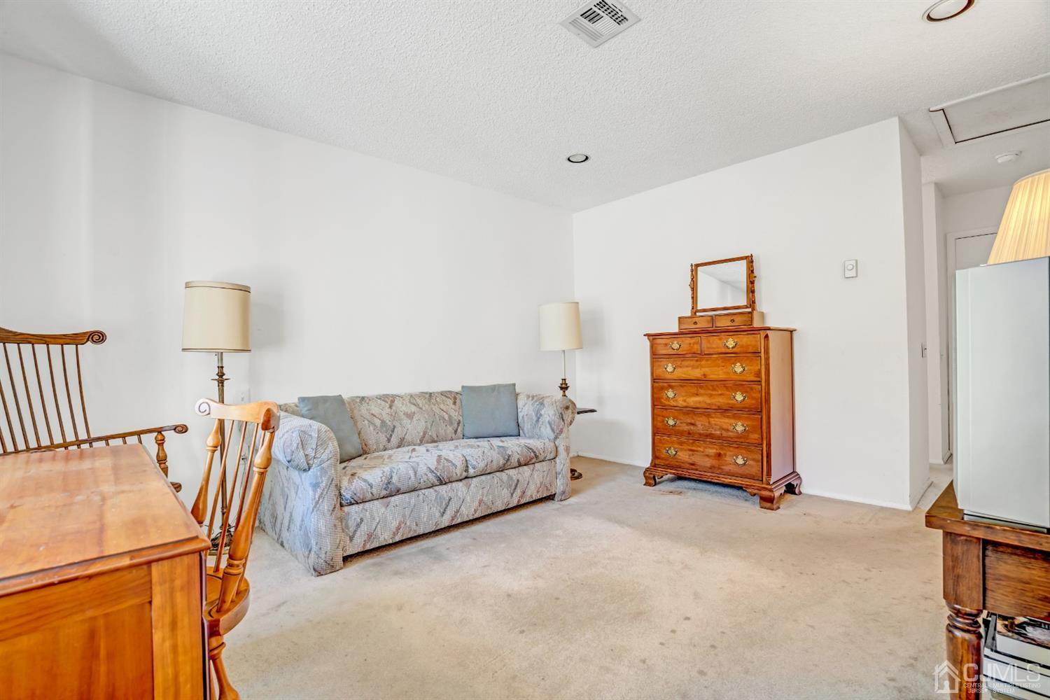 786 Pompton Road, Unit B Monroe Township, NJ 08831 - Photo 23 of 28 a living room with furniture and a flat screen tv