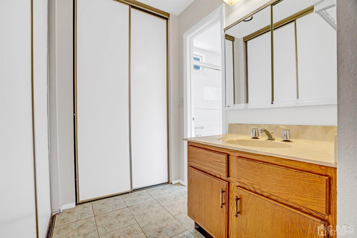 786 Pompton Road, Unit B Monroe Township, NJ 08831 - Photo 24 of 28 a bathroom with a sink and a mirror