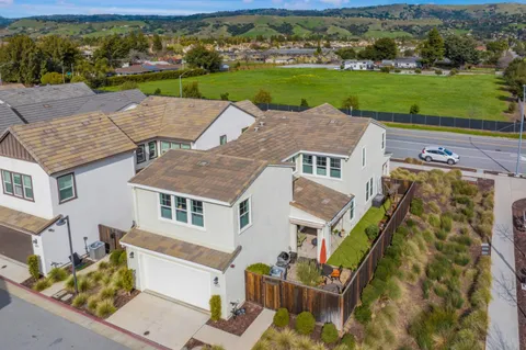 a view of a big house with a big yard and large trees