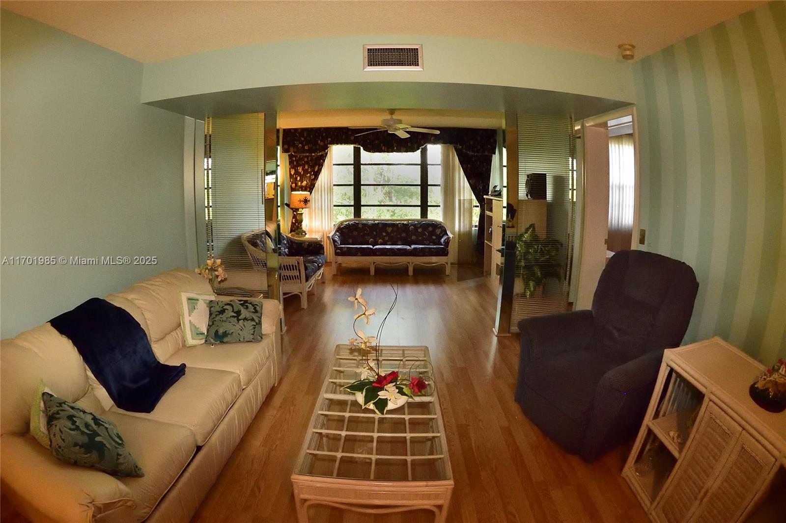 6085 Balboa Circle, Unit 402 Boca Raton, FL 33433 - Photo 2 of 21 a living room with furniture and a large window