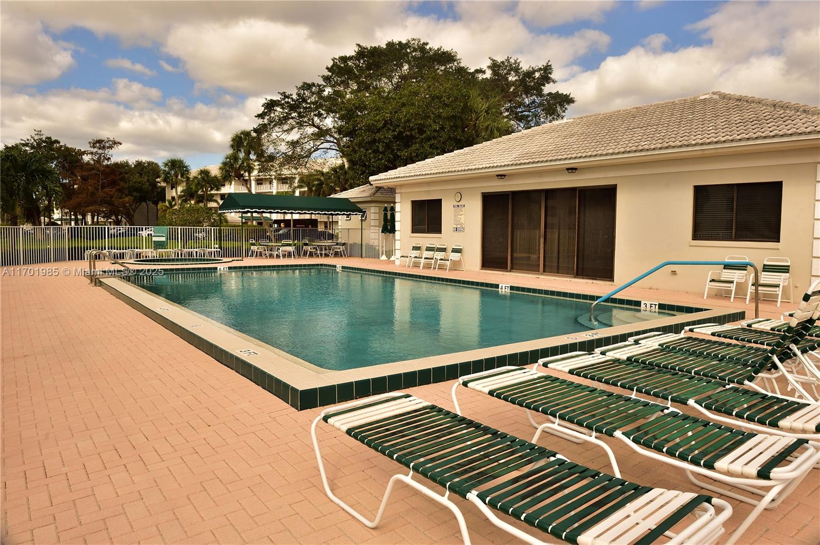 6085 Balboa Circle, Unit 402 Boca Raton, FL 33433 - Photo 21 of 21 a view of a swimming pool with a lounge chairs