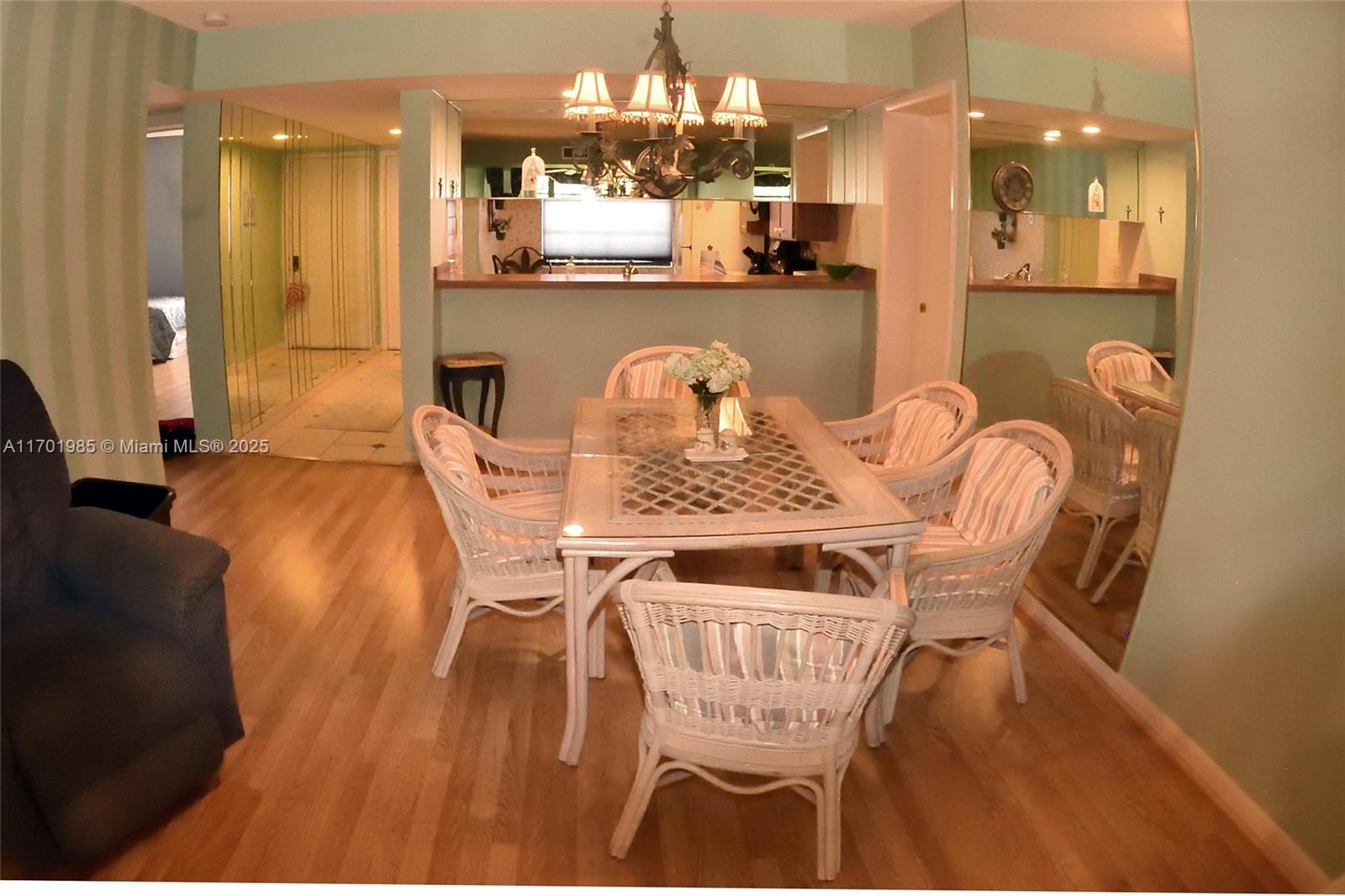 6085 Balboa Circle, Unit 402 Boca Raton, FL 33433 - Photo 4 of 21 a view of a dining room with furniture and chandelier