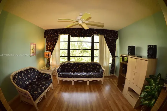 a bedroom with wooden floor and a bed