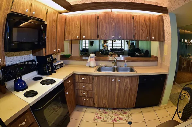 a kitchen with a sink and a stove top oven