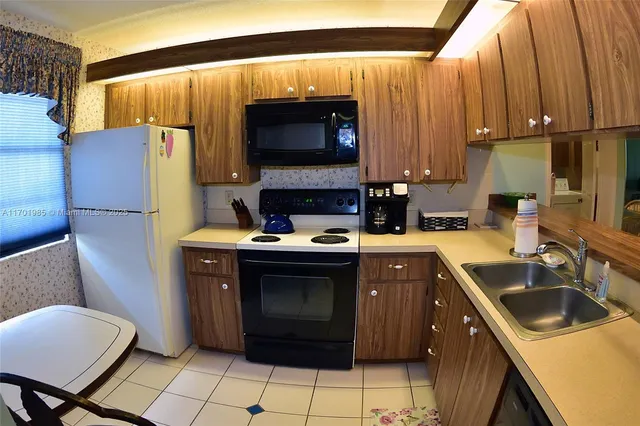 a kitchen with a sink cabinets and appliances