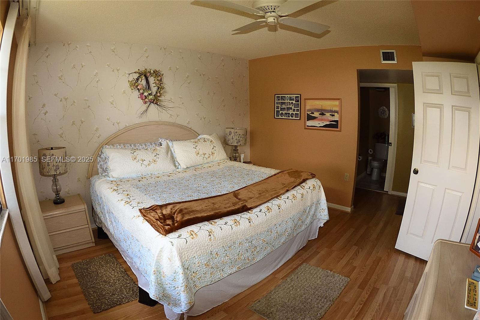 6085 Balboa Circle, Unit 402 Boca Raton, FL 33433 - Photo 9 of 21 a bed sitting in a bedroom next to a window