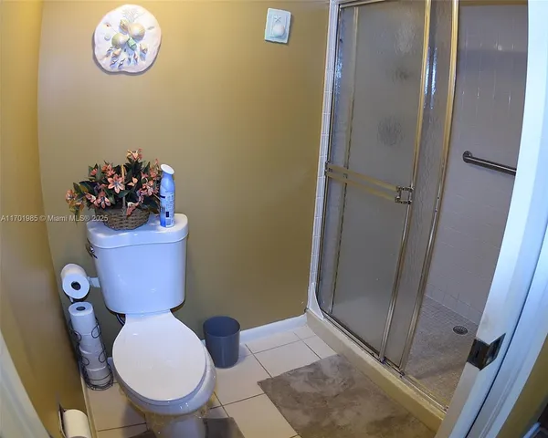 a bathroom with a toilet and a shower curtain