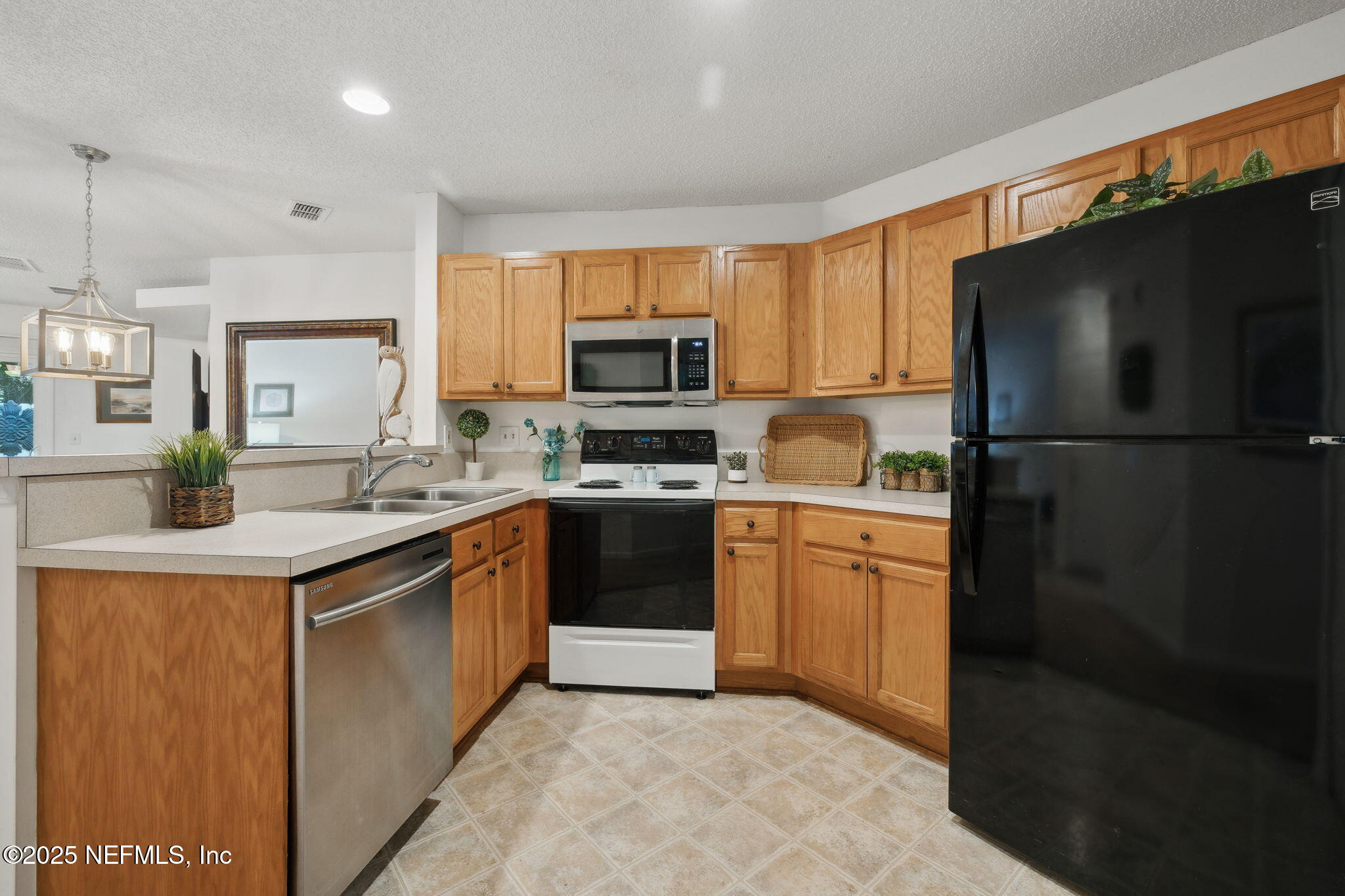 905 Country Bridge Road, Unit 1 St. Johns, FL 32259 - Photo 14 of 43 a kitchen with a refrigerator a stove top oven a sink and cabinets