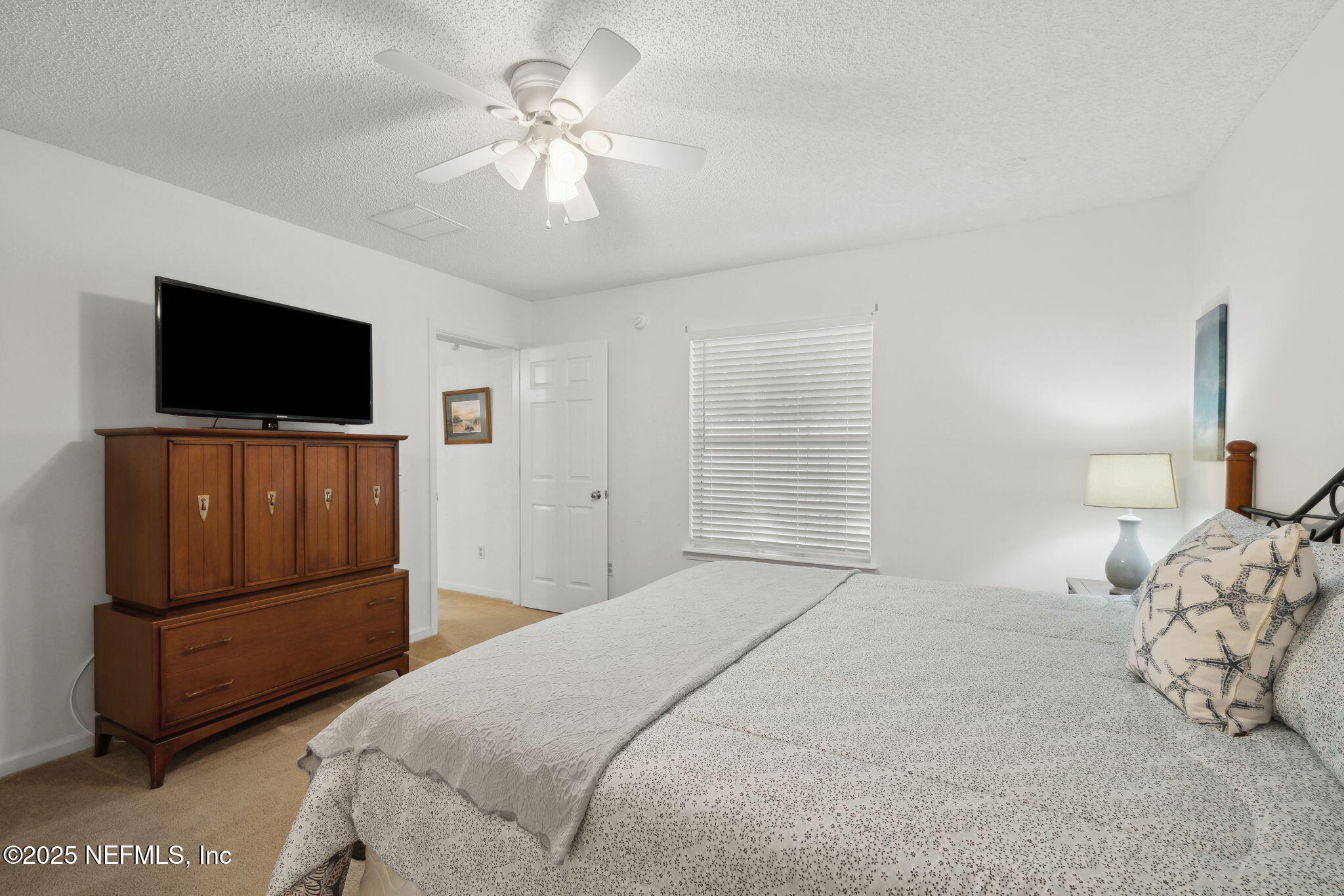 905 Country Bridge Road, Unit 1 St. Johns, FL 32259 - Photo 20 of 43 a bedroom with a bed and a flat screen tv